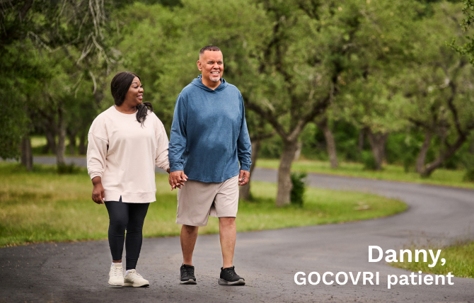 GOCOVRI patient Danny walking outdoors with his wife and care partner, Sylvia.
